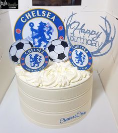 a birthday cake decorated with soccer balls and chelsea crests