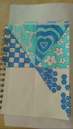 an open notebook with blue and white designs on it