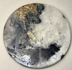 a black and white plate with gold paint on it