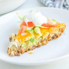 a slice of quiche with sour cream on top