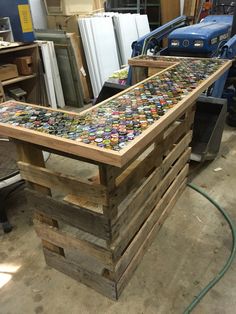 a table made out of wooden pallets with many different types of buttons on it