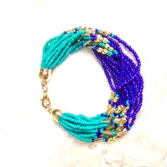 New*Hand Crafted*Glass Seed Bead*12 Strand Bracelet*. Turquoise, Navy Blue & Gold Pltd Seed Beads. Gold Pltd End Caps. 7"Long With A 3"Extender. Pretty Bracelet*Southwest/Bohemian Style. Made By Sharon. Smoke Free Home. Blue Bohemian Bracelets With Colorful Beads, Bohemian Blue Bracelets With Colorful Beads, Blue Multi-strand Hand-strung Bracelet, Blue Hand-strung Multi-strand Bracelet, Blue Bohemian Beaded Bracelets With Faceted Beads, Bohemian Blue Beaded Bracelets With Faceted Beads, Blue Bohemian Beaded Bracelets With Large Beads, Blue Multi-strand Hand-strung Beaded Bracelets, Blue Multi-strand Beaded Bracelets With Tiny Beads