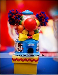 a gummy machine filled with lots of different colored candies and balloons on top of it