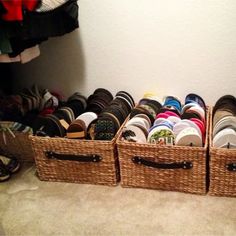 two baskets filled with shoes sitting next to each other on the floor in front of a wall