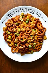 a white plate topped with cereal and pretzels on top of a wooden table