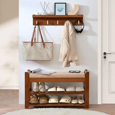 a wooden shoe rack with shoes and purses on it next to a white door