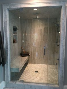 a walk in shower sitting inside of a bathroom