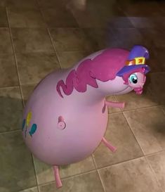 an inflatable toy with a hat on it's head is standing on the floor