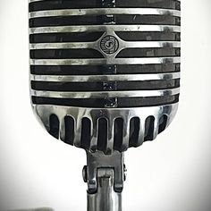 an old fashioned microphone is shown in black and white colors, with stripes on it