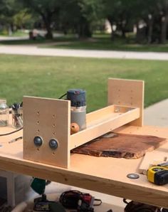 a workbench with tools and materials on it in the middle of a park