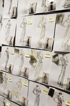 many different dresses are on display at the fashion show, with paper notes attached to them