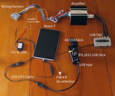 an electronic device is shown with wires and other parts attached to it on a wooden table