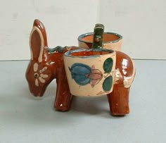 a ceramic elephant planter with two pots on it's back and one in the shape of an elephant