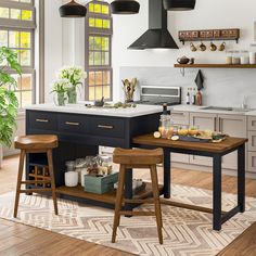 a kitchen with an island and stools in it