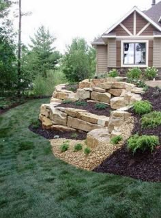 a large rock garden in front of a house