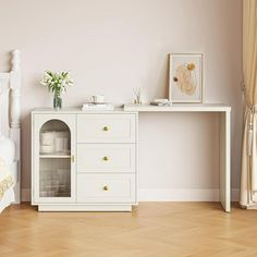 a bedroom with a bed, dresser and pictures on the wall