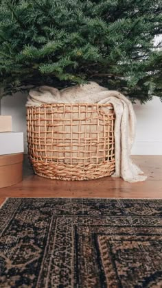 a basket under a christmas tree on the floor