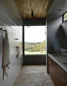 a bathroom with a large window next to a sink