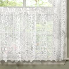 a window with white lace on it