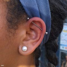 a close up of a person wearing ear piercings