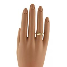 This is an iconic ring by Tiffany & Co. It is called the double hook design and is crafted from solid 18k yellow gold in a high polished finish, the hook front has two bead stops at each end. The thick wire band is fit comfortable on the finger. It is fully signed with the designer name and metal content.  Metal:  18k yellow gold      Hallmark: T&Co. 750 Measurement:  Front:  11mm across x 7mm wide x 6mm high Ring Size:  5    17mm across the inside of the band Weight:   3.2 grams Designer Name, Hook Design, The Double, Tiffany & Co., Band Ring, Hallmark, Band Rings, Ring Size, Yellow Gold