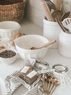 the kitchen counter is cluttered with cooking utensils