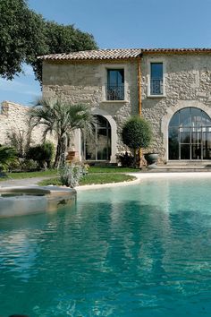 a large house with a pool in front of it