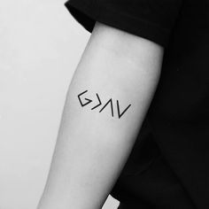 a woman's arm with the word vkg tattooed on her left arm