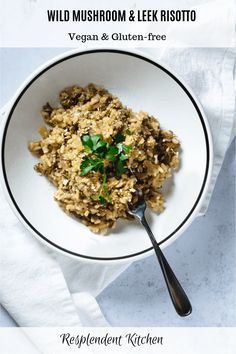 wild mushroom and leek risotto in a white bowl with a black spoon