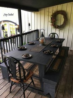 the table is set on the porch for two people to sit down and enjoy their meal