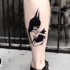 a person with a cat tattoo on their leg