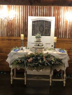 the table is decorated with greenery and lit candles for an elegant touch to the room