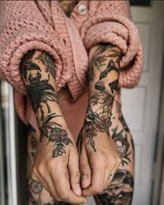 a woman with tattoos on her arms and hands