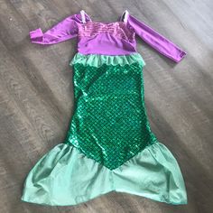 the little mermaid costume is laying on the floor