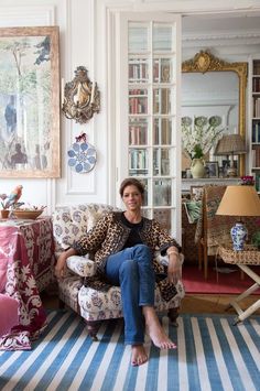 a woman sitting on a couch in a living room