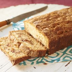 a loaf of bread sitting on top of a table next to a knife