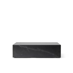 a black box sitting on top of a white surface