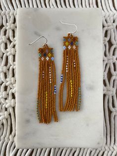 the beaded earrings are made with seed beads