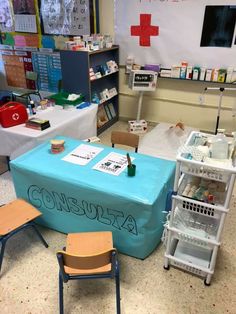 a blue table with writing on it in a room filled with medical supplies and desks