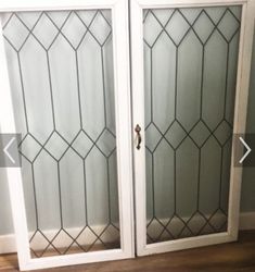 two glass doors in the corner of a room