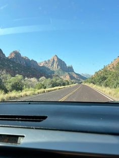 the view from inside a car looking at mountains