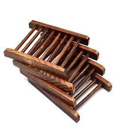 four pieces of wood stacked on top of each other in the shape of a rack