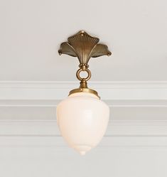 a light that is on the ceiling in a room with white walls and trimmings