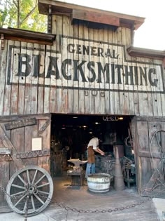 an old wooden building with the words general blacksmithing painted on it