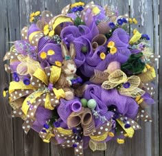 a purple wreath with yellow and brown bows