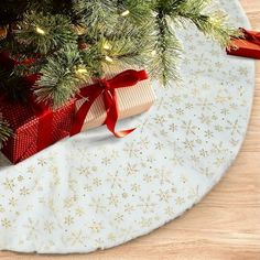 a christmas tree skirt with presents under it