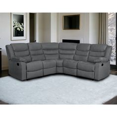 a large gray sectional sofa sitting on top of a white rug