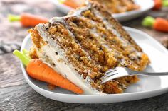 a slice of carrot cake on a white plate with a fork in front of it