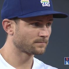 a close up of a baseball player wearing a hat and looking off to the side