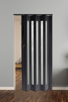 a room divider with three panels in black and white, against a gray wall